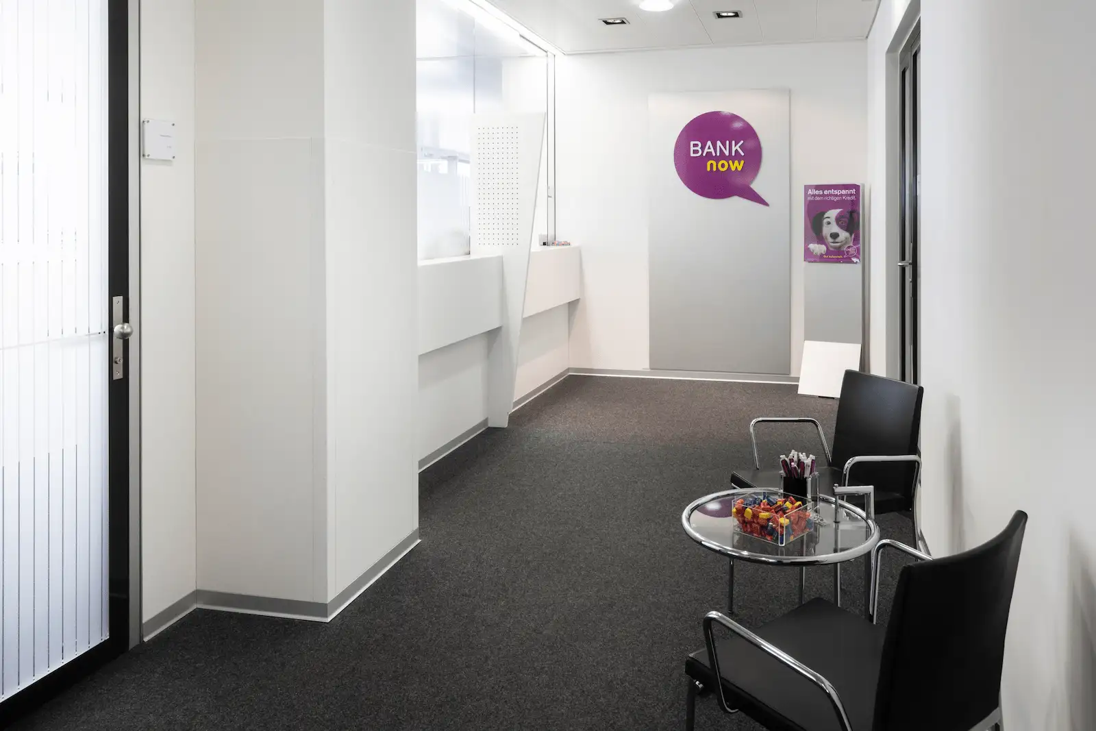 Interior entrance area of the BANK-now Zurich-Oerlikon branch with seating and bright interior.